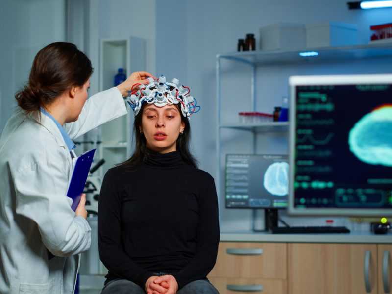 neurological doctor cheking eeg headset explaining treatment